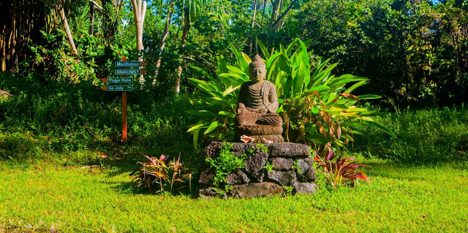 Meditation sculpture surrounded by tropical gardens at KMEC in Pāhoa