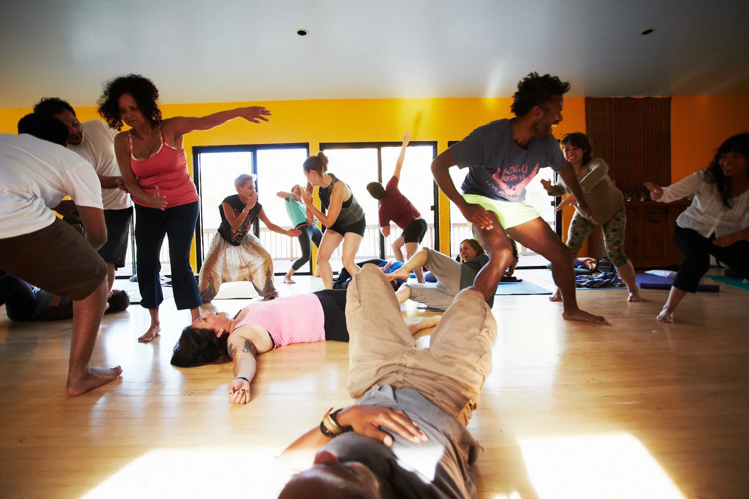 Guests practicing yoga together inside KMEC’s Yoga Hale